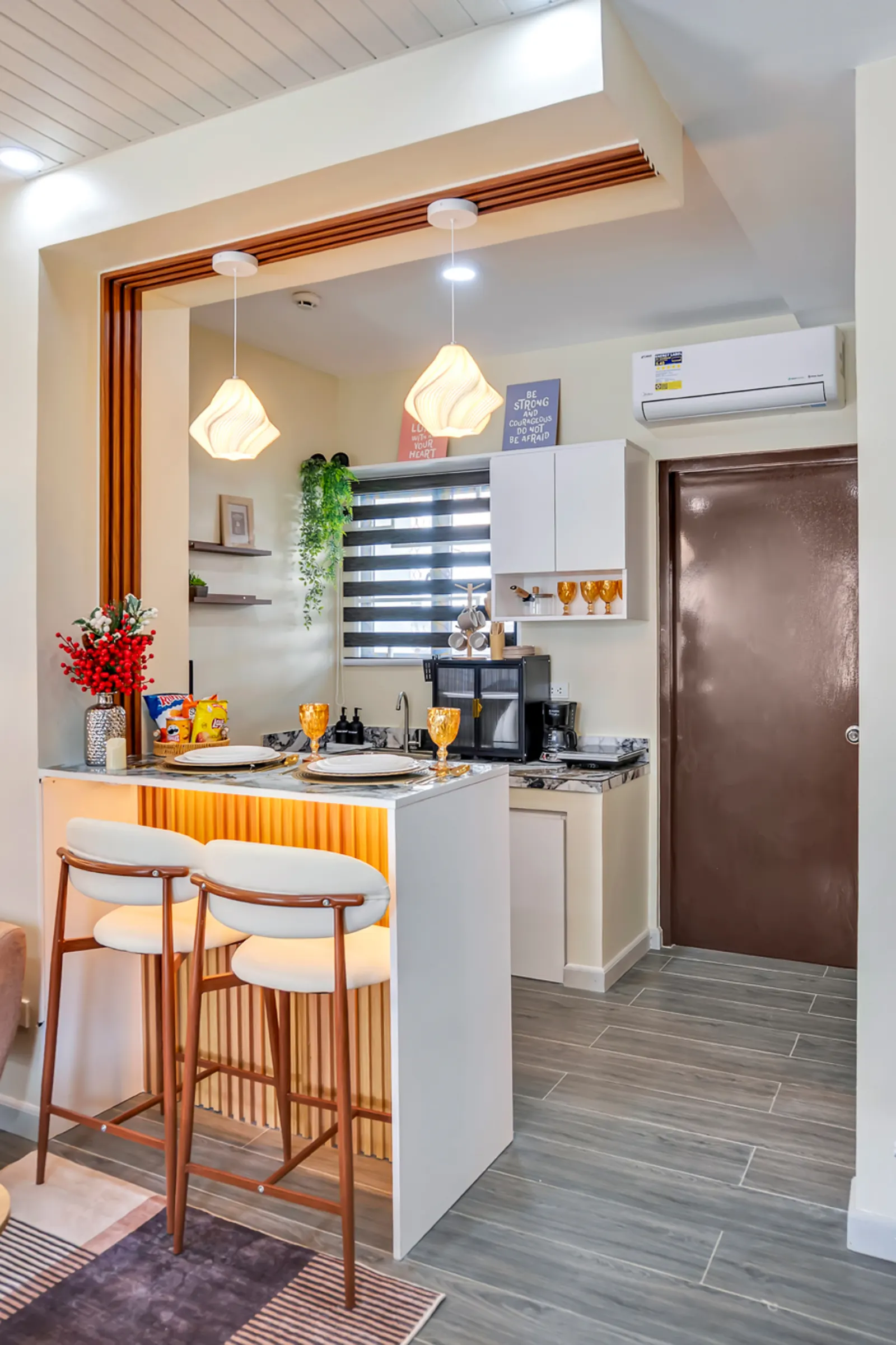 Kitchenette with dining counter and pendant lights
