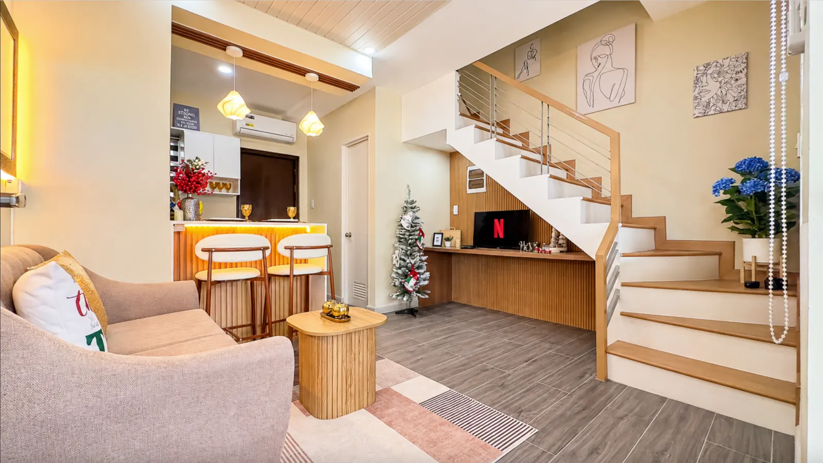 Living room with sofa, bar counter and staircase