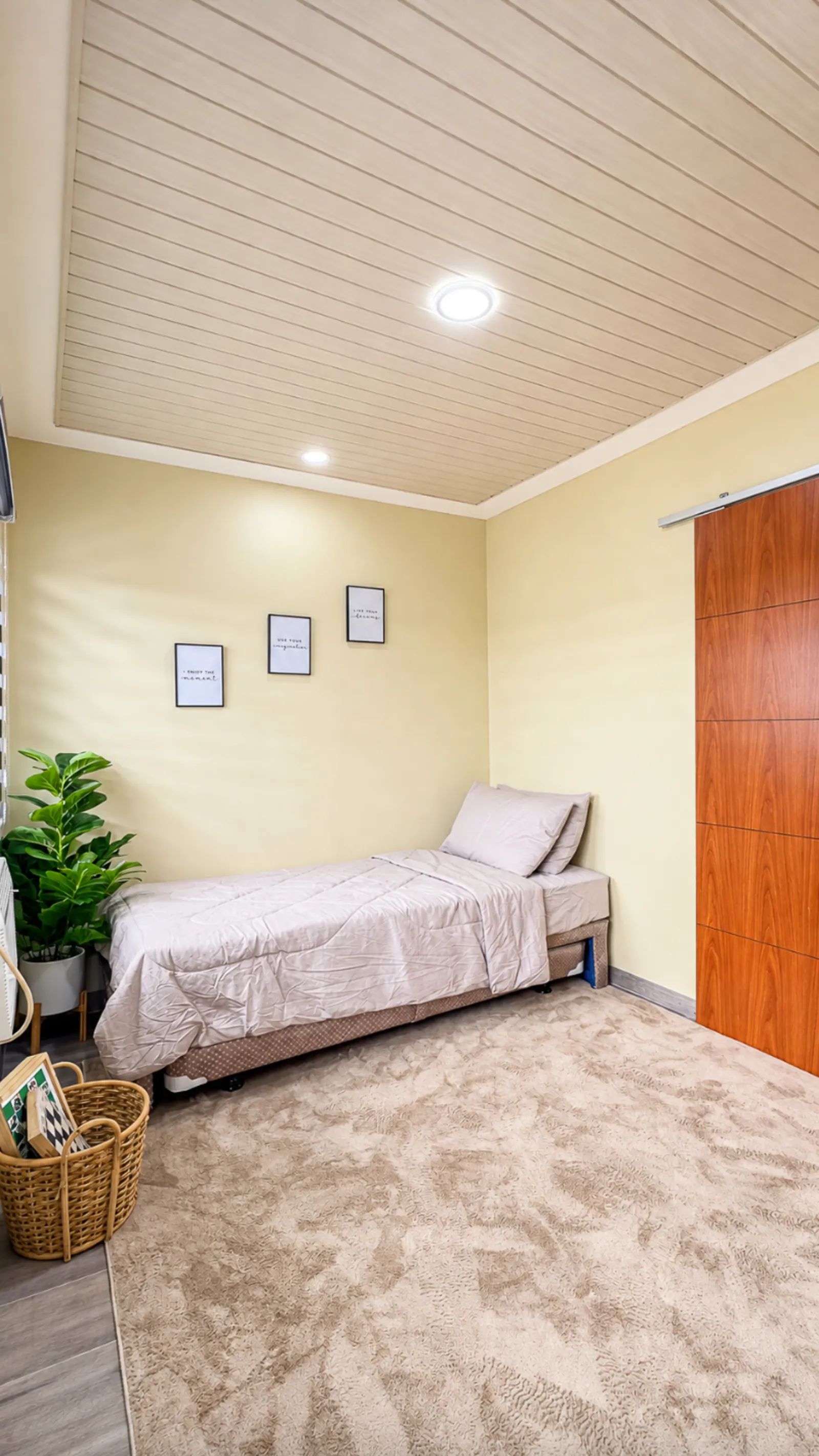 Bedroom with single bed and framed prints
