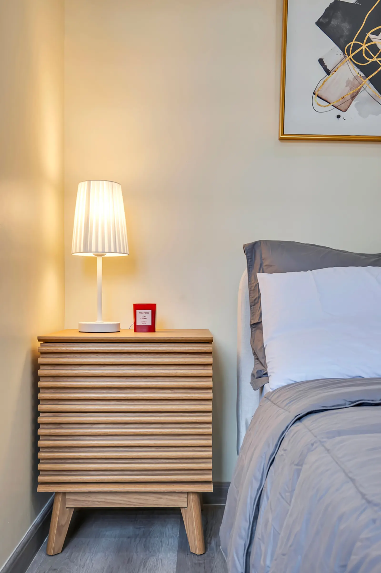 Bedside lamp on a wooden nightstand
